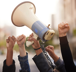 Image showing Protest, fist hands and megaphone in city street for solidarity, fight for human rights or government law change in community. Diversity support, justice and black people crowd for freedom of speech