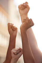 Image showing Hands fist and justice of power by people in protest for freedom, equality and change in a street. Community, action and government rally by man and woman in solidarity for society democracy