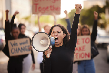 Image showing Woman, megaphone and fist in community protest for change, gender based violence or equality in the city. Angry women activist standing together in march strike for human rights or government action