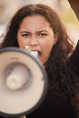 Image showing Woman, megaphone and protest in the city for human rights, gender based violence or equality in the outdoors. Female activist shouting, screaming and speaker for discrimination, community or change