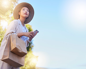 Image showing Asian, woman with bags and shopping with smartphone mockup for internet deals, online sales and ecommerce promo outdoors. Japanese customer, retail and online shopping waiting for taxi with cellphone