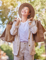 Image showing Grocery shopping, happy and woman in the city for groceries, thinking of sale and food discount in Singapore. Retail smile, shopping bag and Asian person with an idea for products from a supermarket