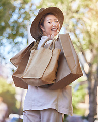 Image showing Shopping, street and woman portrait from Japan happy about retail sales and fashion deal. Sale, walking and Asian person with happiness and store bags with a smile from mall promotion and discount