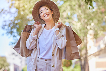 Image showing Asian woman, shopping and smile with bags for outdoor retail experience, buying or purchase in fashion. Happy Japanese female shopper smiling in happiness for wealth, style and clothing outside