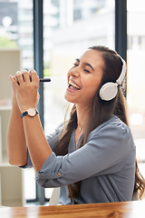 Image showing Woman, singing and listening to music with smile for streaming, entertainment and headphones at the office. Happy female smiling for audio track, sing and sound for fun, hifi and chilling at work