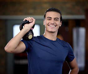 Image showing Fitness, portrait or man at gym with a kettlebell for strong arms or training biceps in workout or weightlifting exercise. Smile, face or happy personal trainer ready for coaching with wellness goals