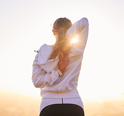 Image showing Fitness, stretching and woman exercise at sunset for training, wellness and running in nature, rear view and body preparation. Sports, stretch and girl runner getting ready for workout at sunrise