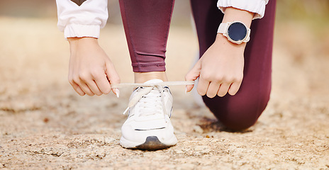 Image showing Woman, shoes lace and fitness runner outdoor in nature park for marathon training, cardio run or healthy workout. Athlete person feet, check sneakers and running wellness or exercise in city road