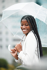 Image showing Stylish, trendy woman with an umbrella in the city for insurance on a cold winter day. Rain, weather and elegant female with style covering herself in an urban town in a fashionable jacket