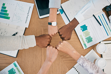 Image showing Diversity, fist hands and teamwork with documents on table for marketing business meeting, creative collaboration and goals support motivation. Team, circle hand and planning strategy or logistics