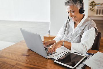 Image showing Call center, receptionist and senior consultant working on a laptop, headset and tablet in the office. Customer support, hotline and elderly female telemarketing agent typing on computer in workplace