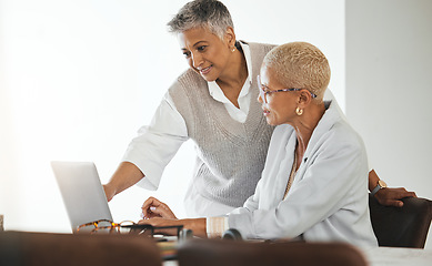 Image showing Laptop, office and senior business women in collaboration planning a corporate project together. Teamwork, professional and elderly manager helping a mature employee with a report in the workplace.