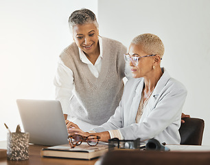 Image showing Laptop, office and senior business women in collaboration planning a corporate project together. Teamwork, professional and elderly manager helping a mature employee with a report in the workplace.