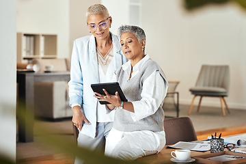 Image showing Tablet, discussion and senior business women in office for planning, strategy and brainstorming ideas together. Communication, digital marketing and female entrepreneurs in conversation for startup