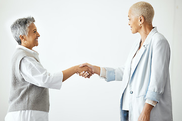 Image showing Partnership, handshake and business women in corporate workplace for teamwork, business deal and collaboration. B2b network, support and female workers shaking hands for agreement, goals and trust