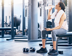 Image showing Fitness, gym and woman drinking water after workout for hydration, health and wellness training. Sports, athlete and lady enjoying aqua drink while taking rest during intense exercise in sport center