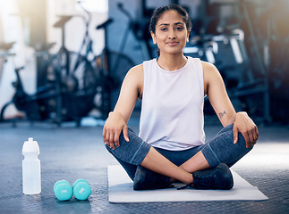 Image showing Woman, crossed legs or stretching on gym mat in healthcare wellness, muscle pain relief or fitness flexibility. Portrait, happy sports athlete or personal trainer in pilates, workout or training club