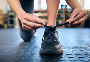 Image showing Tie, fitness or hands with shoes at gym for training, exercise or workout with motivation for a healthy lifestyle. Wellness, goals or sports athlete with foot wear ready to start exercising a club