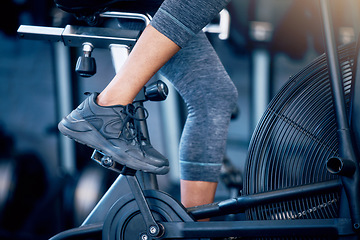 Image showing Closeup, fitness and person training, bike and exercise for wellness, gym and sneakers. Athlete, healthy female and bicycle for cardio, strong and power for legs workout, health or sports for cycling