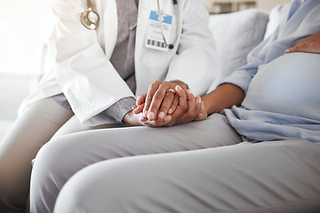 Image showing Healthcare, doctor sitting and holding hands with pregnant woman on sofa for care, trust and support in medicine. Gynecologist, woman and pregnancy, helping hands encourage new mother with empathy.