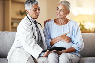 Image showing Pregnant, woman and senior ivf doctor on tablet for planning, results and discussion on sofa during home checkup. Healthcare, pregnancy and consulting with mature doc while checking online plan