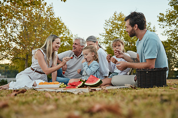 Image showing Watermelon, love or big family in nature on a picnic eating healthy fruit or food on summer holiday vacation in Berlin. Grandparents, mother and happy father enjoy bonding or relaxing with children