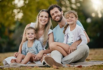 Image showing Family, park picnic and portrait with smile, love and happiness for bonding on blanket, grass and sunshine. Young happy family, lawn and parents with kids, trees and relax together for summer holiday