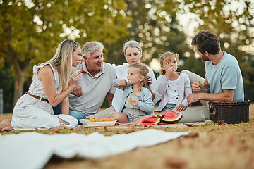 Image showing Happy family, park picnic and summer with fruit, eating and love in nature, holiday and bonding in spring. Big family, healthy watermelon and kids with mom, dad and grandparents on lawn in Melbourne