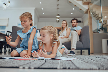 Image showing Relax, children drawing and parents on sofa in the living room bonding, resting and watching the kids. Education, family and girls doing homework on the floor with mother and father sitting on couch.