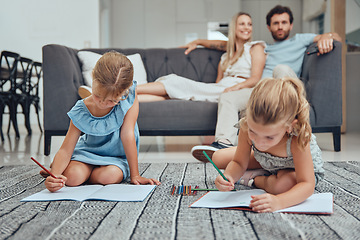 Image showing Living room, parents relaxing and children drawing in books on the floor in their modern home. Mother, father and girl kids sitting in the lounge together to rest, draw and bond in their house.