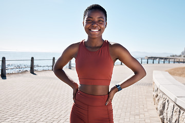 Image showing Fitness, portrait or black woman runner ready for cardio training, workout or exercise by a beach in Cape Town. Wellness, face or healthy sports girl with a happy smile or freedom with body goals