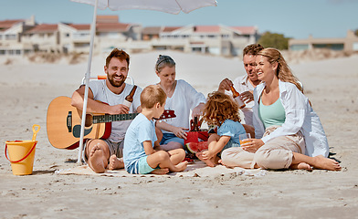 Image showing Summer, picnic and family with guitar at beach enjoying holiday, weekend and vacation on Miami beach. Love, bonding and children with grandparents, mom and dad with musical entertainment outdoors