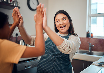 Image showing Happy family, mother and girl high five for cooking support, learning or child development in a house kitchen. Goals, success or excited mom loves teaching a young kid baker baking or food skills