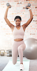 Image showing Black woman, dumbbell exercise and lunge in gym for sports, training or strong body in Nigeria fitness club. Portrait, young female and lifting weights with balance, muscle power and wellness energy