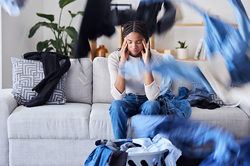 Image showing Laundry, clothes or black woman with stress, headache or anxiety frustrated with cleaning, washing basket or housekeeping. Burnout, fatigue or tired African girl cleaner resting on living room sofa