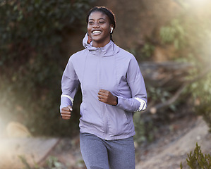 Image showing Black woman, running and outdoor for exercise, training or fitness for health, wellness or smile. Jamaican female, healthy athlete or runner in nature, workout or practice for power, energy or cardio