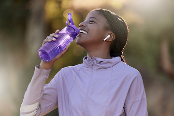 Image showing Exercise, black woman and drinking water for fitness, wellness and health outdoor to relax. Sports, young female Nigerian and athlete hydration, liquid for break and training for workout and earbuds.