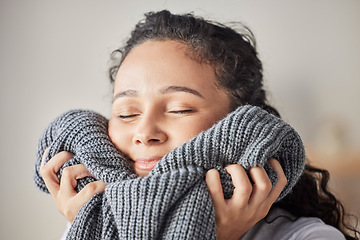 Image showing Happy, woman and fresh laundry in home with satisfied smile on face feeling clean wool sweater. Happiness, wellness and hygiene of girl cleaning in laundry room at house touching soft texture.