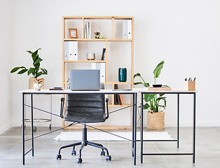 Image showing Empty office, table or desk in a home office interior or office desk with pens, plants or stationery for productivity. Furniture, chair or modern office room with laptop or folders in a wooden shelf