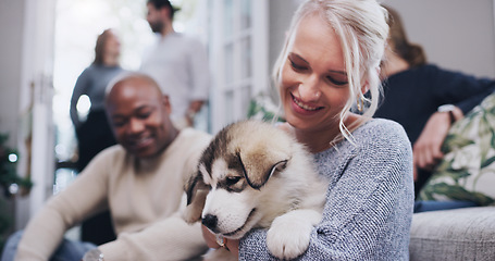 Image showing Friends, family and woman with puppy in living room at Christmas party in family home. Friendship, diversity and dog love, happy woman with smile and new pet at holiday celebration in apartment.