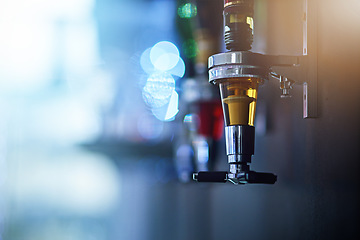 Image showing Alcohol, drink and closeup of tap in nightclub for cocktail shots, pour alcoholic beverage and beer. Bartending, liquor and focus on beer tap for clubbing, restaurant and cocktail bar in background