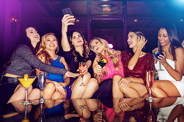 Image showing Selfie, club and women with drinks at a party for new year, birthday or festive celebration. Fun, social and friends taking picture on a phone while drinking alcohol beverage in nightclub together.