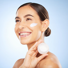 Image showing Woman, beauty and face with cream product for happiness vision, skincare wellness or cosmetics dermatology in blue background. Facial care mockup, luxury sunscreen and salon spa treatment in studio