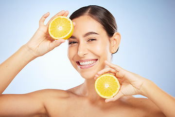 Image showing Woman, skincare portrait and lemon for beauty, health and wellness with vitamin c, happy and smile. Model, fruit and happiness for self care, clean radiant glow and skin by blue background in studio