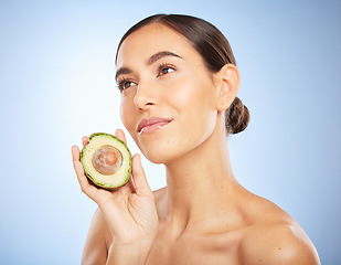 Image showing Beauty, health and skincare with woman and avocado for facial, natural products and detox. Nutrition, spa and diet with face of girl model for self care, wellness and glow in blue background studio