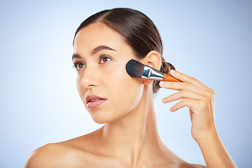 Image showing Woman, face and thinking with makeup brush for skincare beauty, luxury skin wellness and cosmetics dermatology in studio. Facial care, product application or spa vision aesthetic in blue background