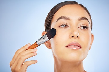 Image showing Beauty, brush or woman in a makeup skincare daily routine for a beautiful glowing smooth face in studio. Colombia, facial or young girl model applying cosmetics products for self love or self care