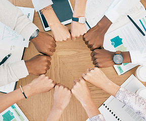 Image showing Diversity, fist hands and teamwork with documents on table for marketing business meeting, creative collaboration and goals support motivation. Team, circle hand and planning strategy or logistics