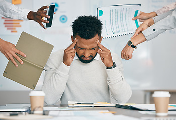 Image showing Stress, burnout and tired black man with headache, frustrated or overwhelmed by coworkers at workplace. Overworked, mental health and anxiety of exhausted male worker multitasking at desk in office.