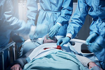 Image showing Doctors, surgery and blood with a medicine team in scrubs operating on a man patient in a hospital. Doctor, nurse and teamwork with a medical group in a clinic to perform an operation